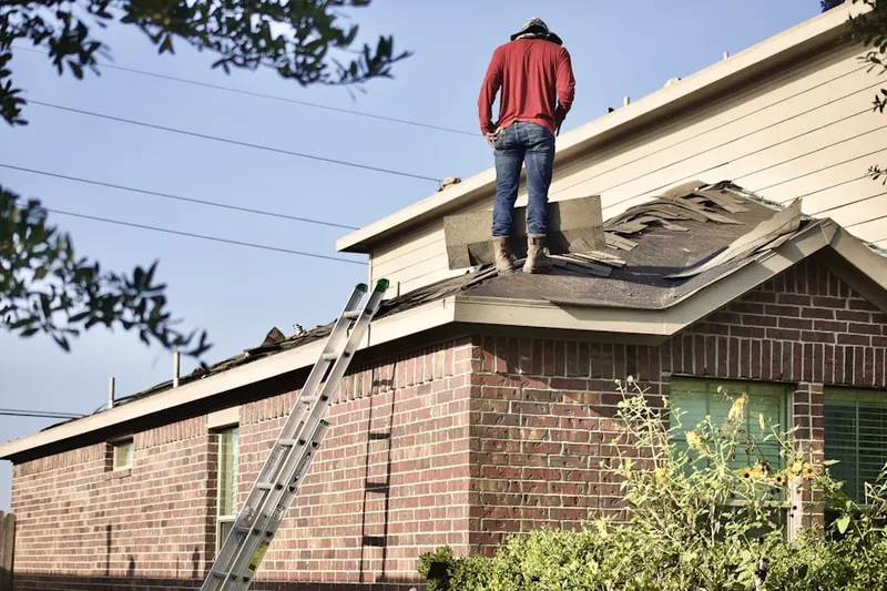 Professional roofer working on a residential roof in McCaslin